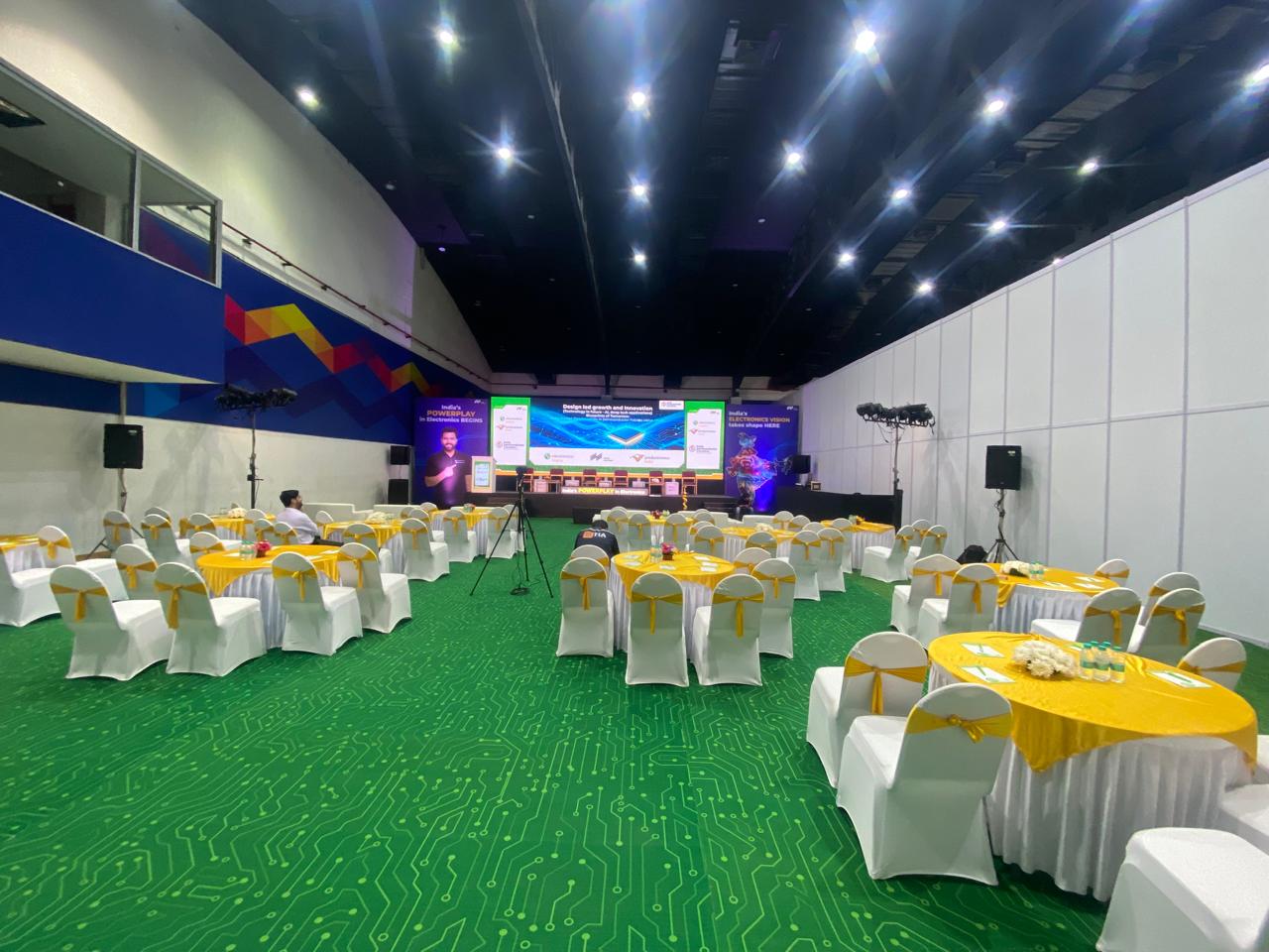 corporate event stage with LED screen, lighting and audience