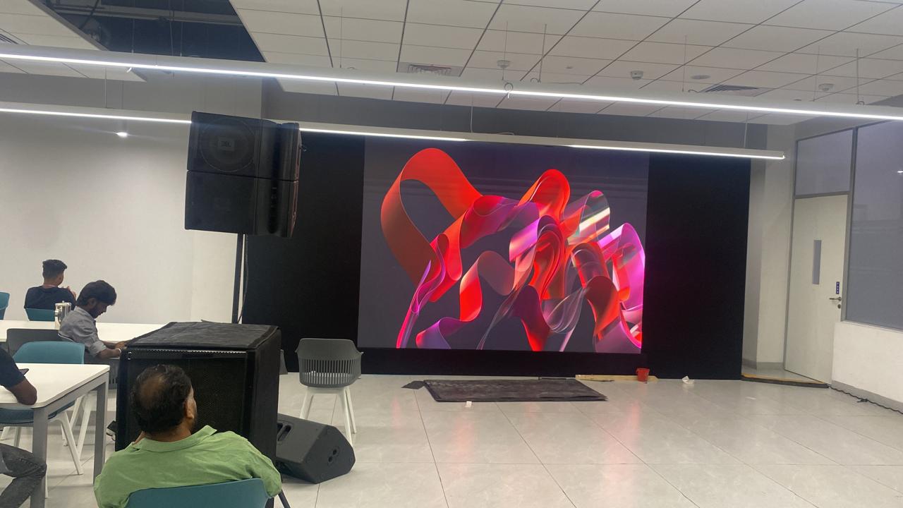 large LED video wall on truss with a technician and flight cases