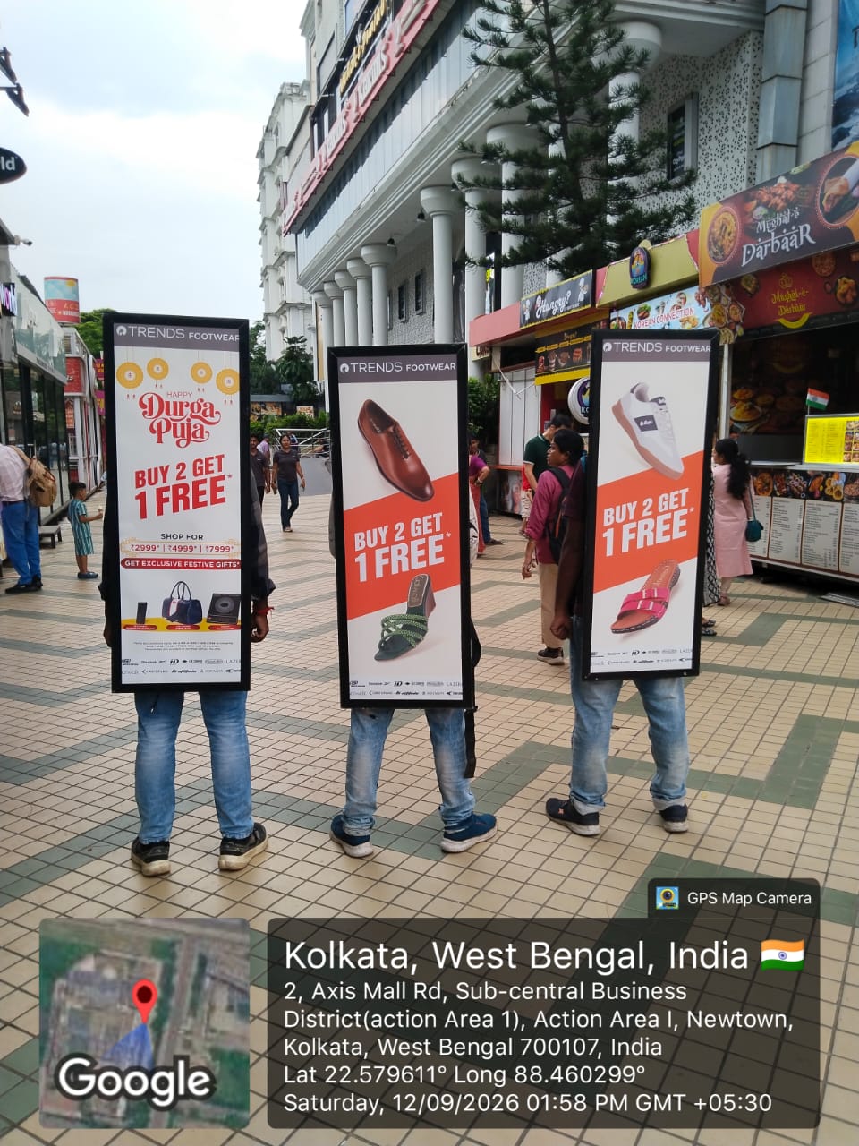 weekend mall kiosk with shoppers gathered around