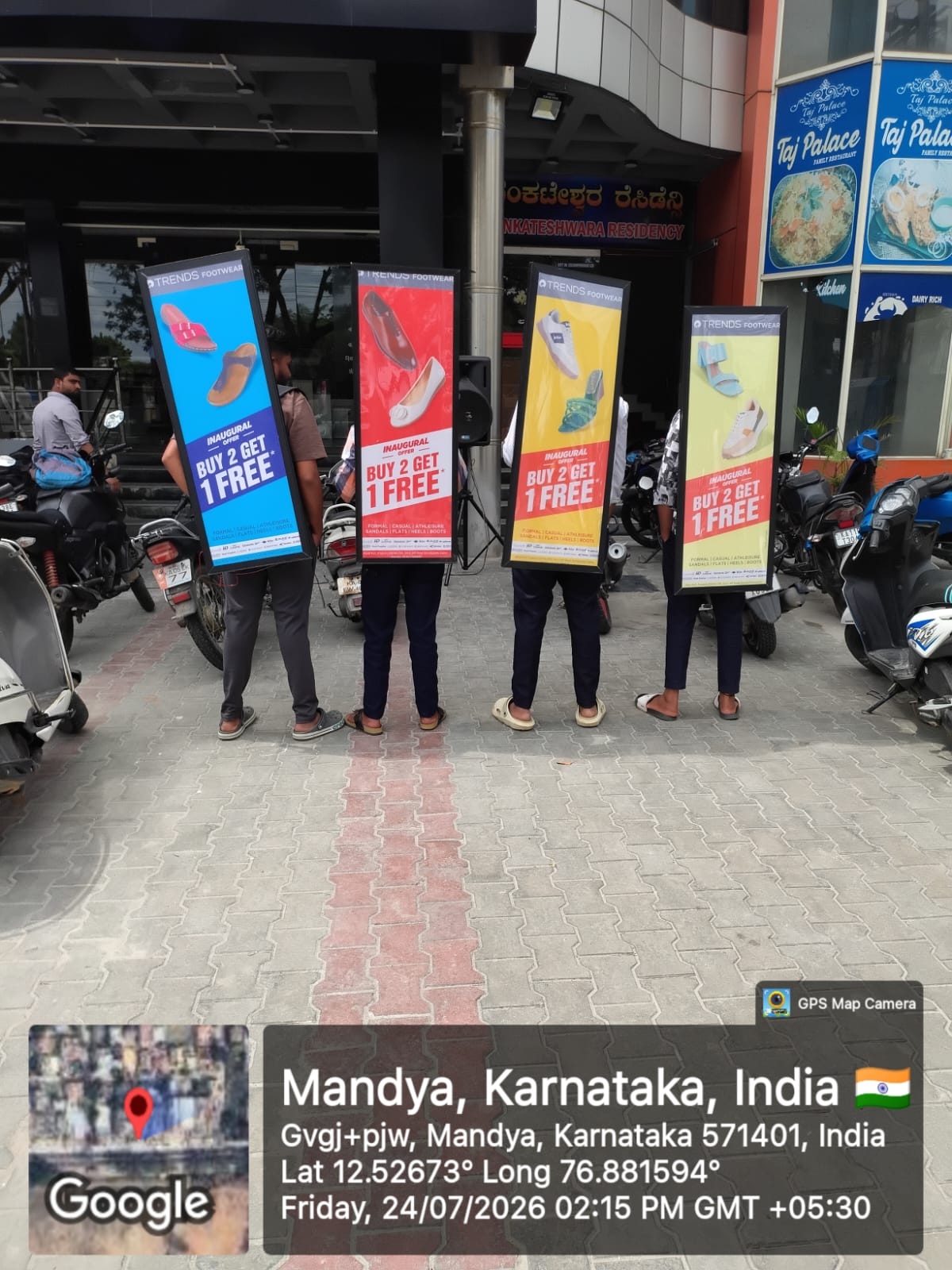 uniformed promoters standing in front of a branded media wall